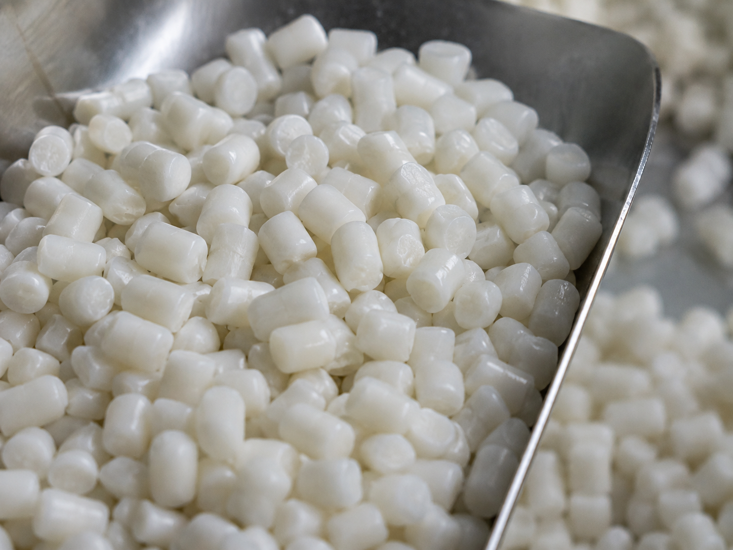 Close-up of white palm-based soap noodle pellets